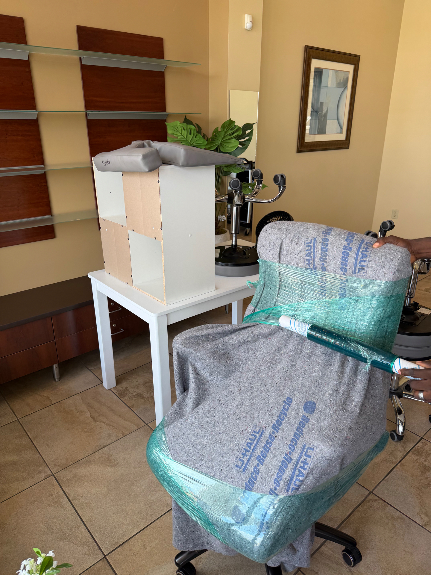 Wrapped office chair and disassembled shelving ready for transport